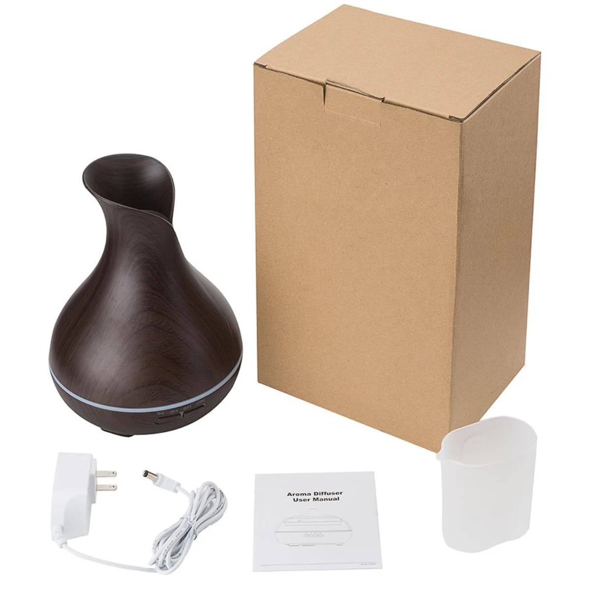 El difusor junto a su caja, el adaptador de corriente, el manual y el vaso medidor
